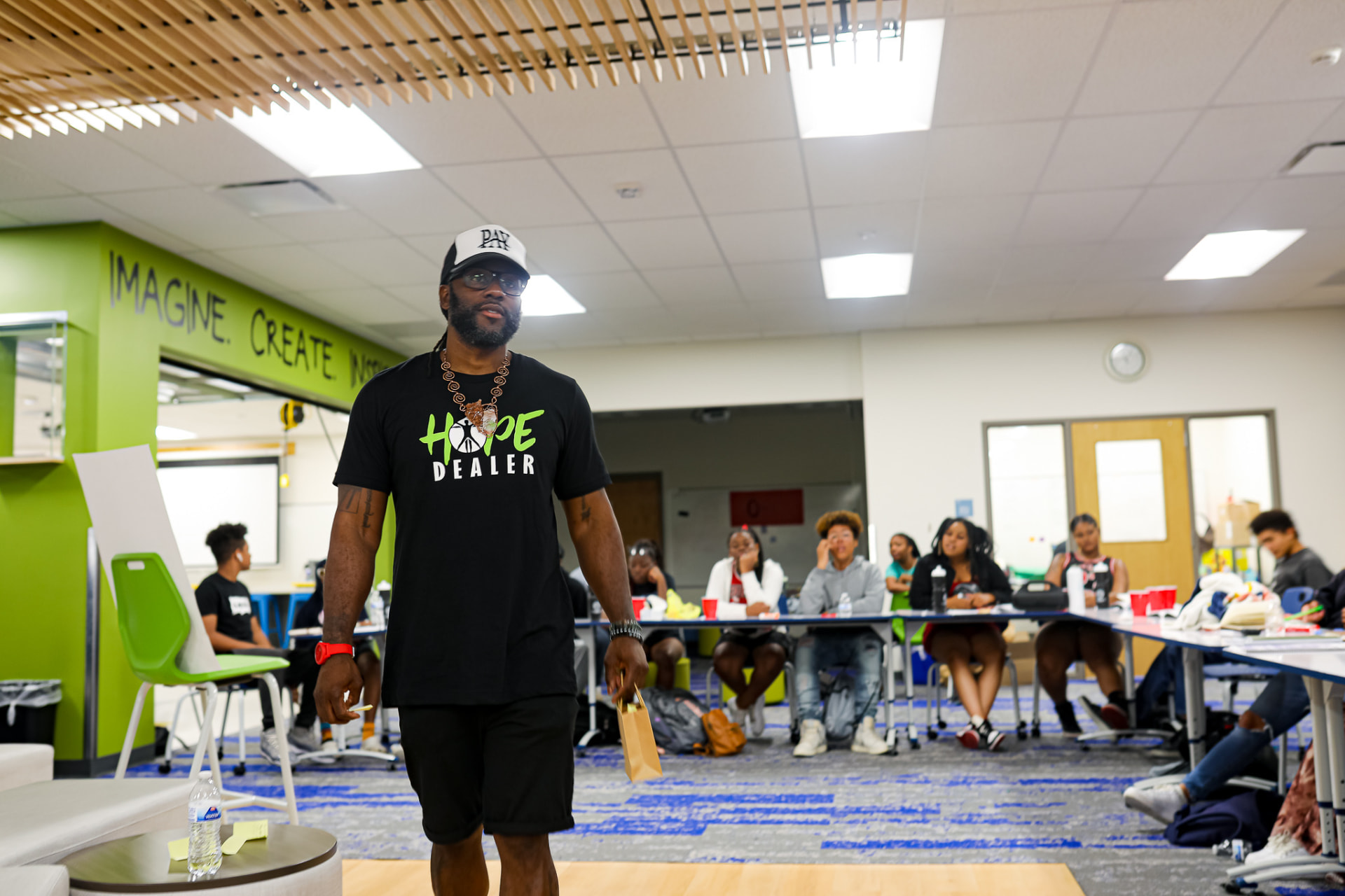 A CARES facilitator leading a session while young people listen around the table